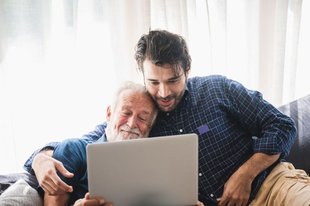 man_with_senior_adult_looking_at_laptop_screen_ind_2026_01_09_08_13_47_utc_fe86b7a514